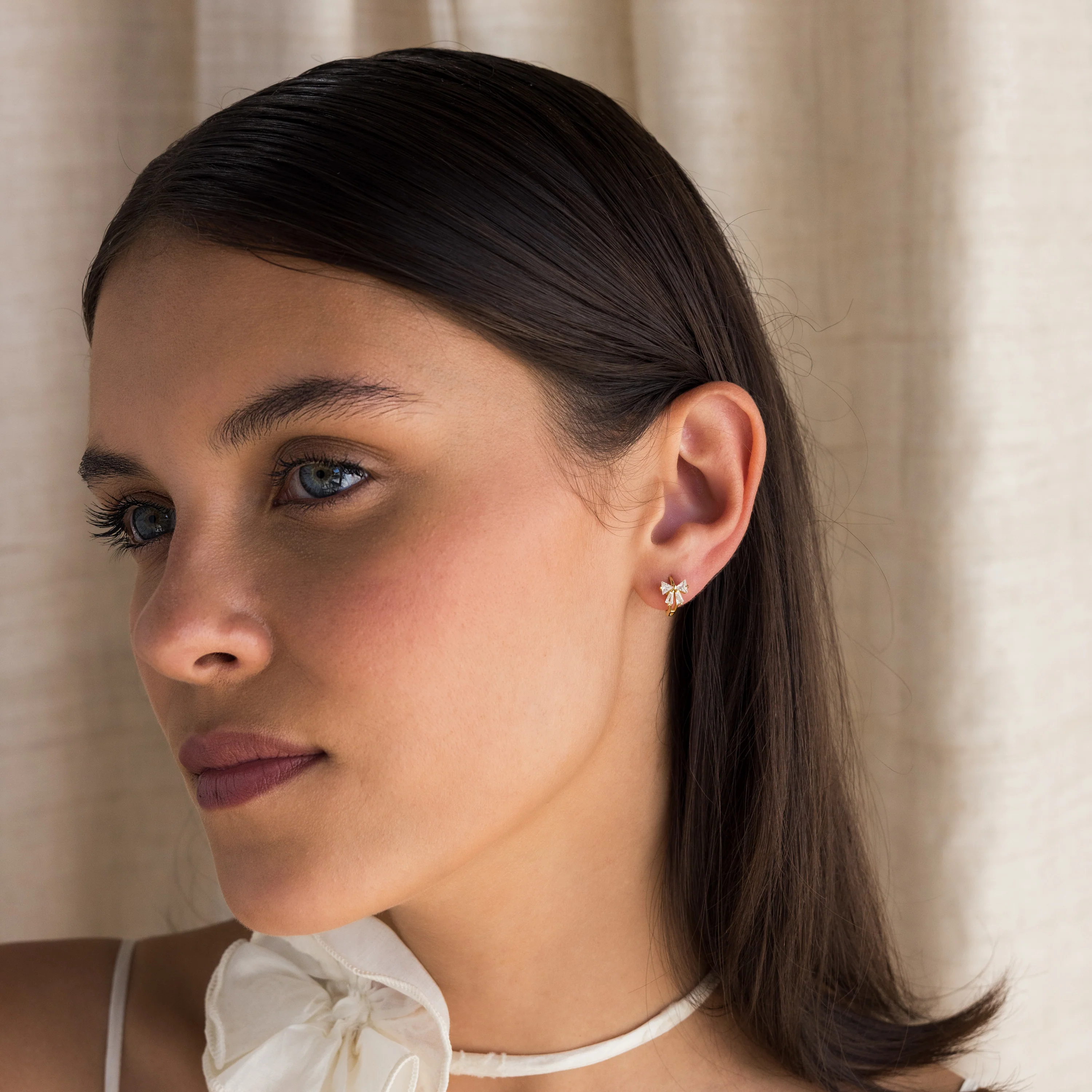 Diamond Ribbon Bow Huggies in 18K Gold - Image 3